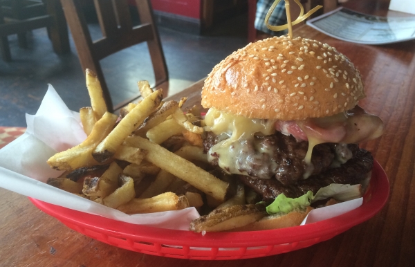 It's the bronx burger y'all. A delicious looking burger oozing with cheese and bacon. 