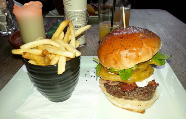 The burger from The Connaught stacked high with a vase of fries.